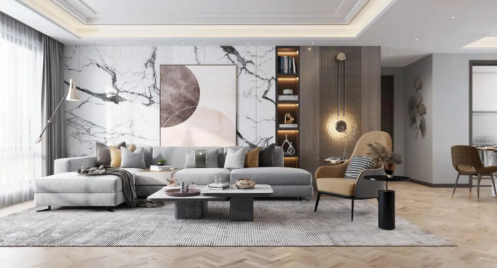 A sophisticated living room with a light gray sectional, a marble accent wall, and a cozy tan accent chair.