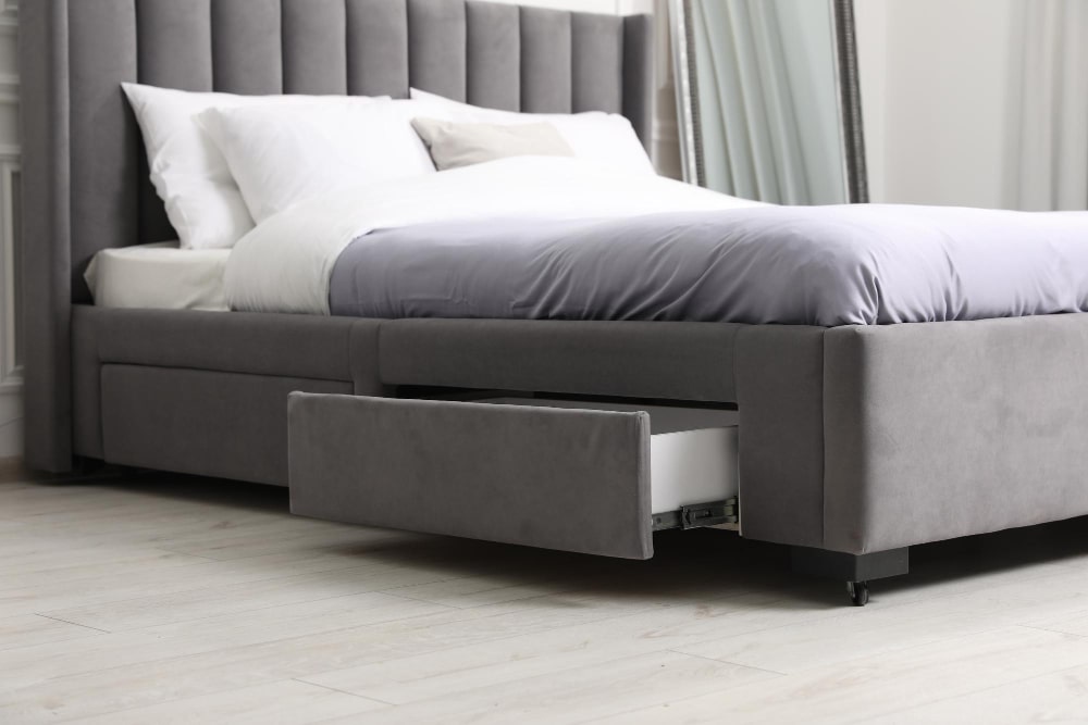 Modern gray upholstered bed with a chic fluted headboard and convenient built-in under-bed storage drawer.