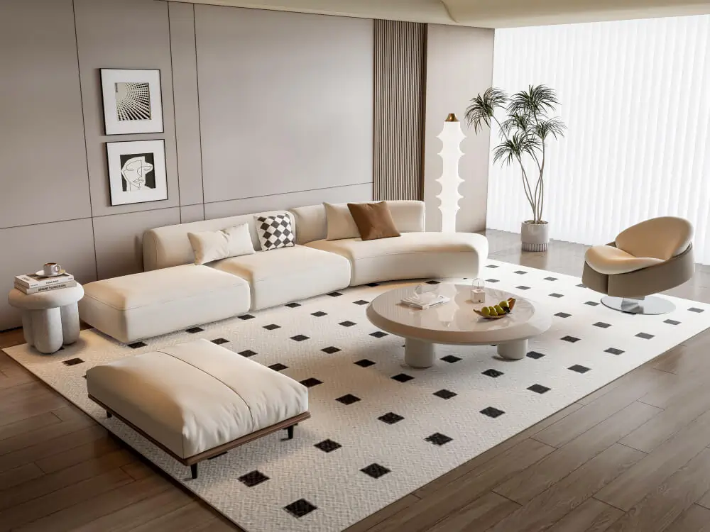 A contemporary living room with a curved white sectional, a matching oversized ottoman, and a round coffee table.