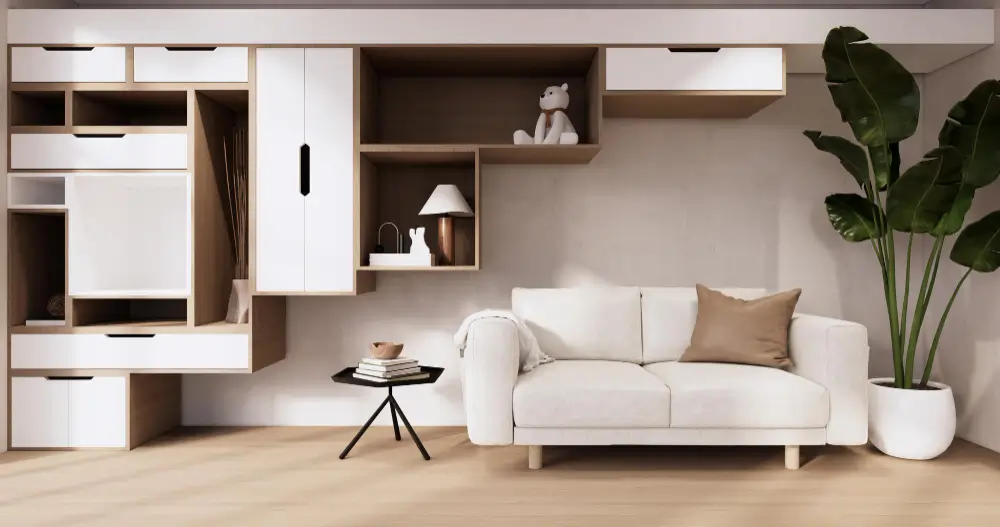 Space-saving furniture for small Dubai apartments with wall-mounted storage, open shelving, and a modern white sofa.